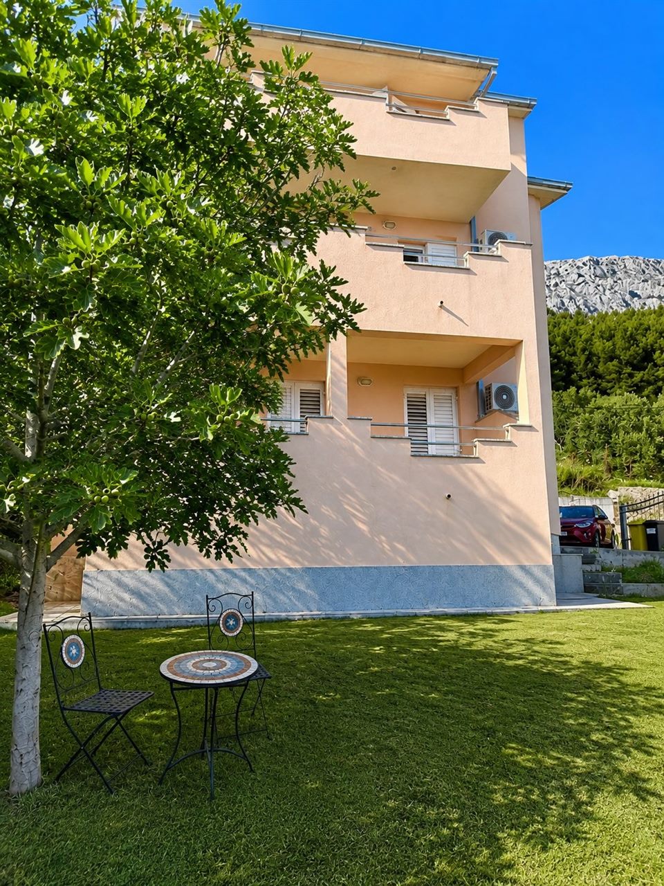 The house with garden and seating under the tree